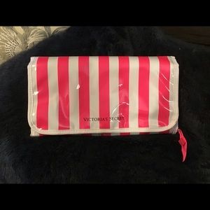 Pink and white striped hanging travel case.